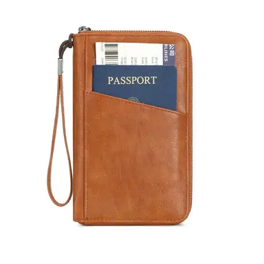 Tan faux leather passport wallet with wrist strap, passport and boarding pass in the front pocket